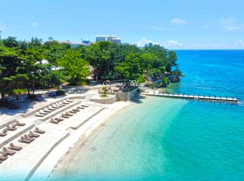 an aerial view of a beach with chairs and the ocean at Mactan Newtown - New Modern Condo with Ocean View in Mactan