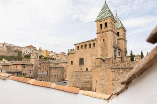 a view of a building with a tower at La Terracita de Bisagra in Toledo