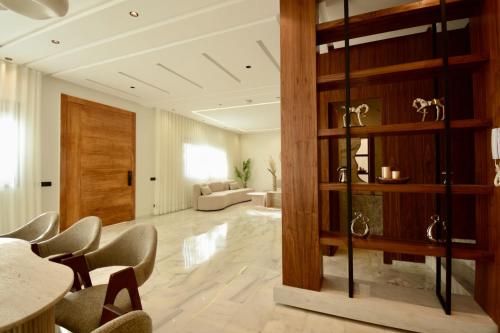 a living room with a table and chairs at Villa Majestic in Hbl Hmid