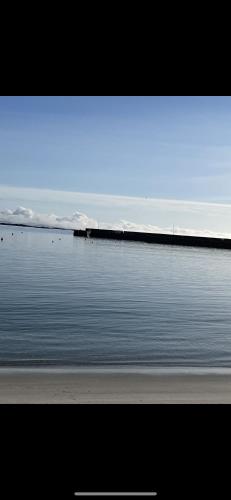 a large body of water with a pier in the background at Pier view house in Ballyconneely