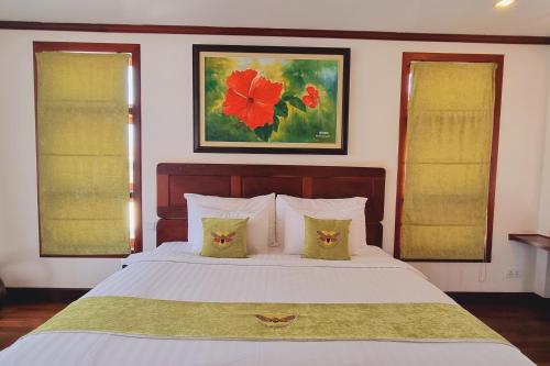 a bedroom with a large white bed with two pillows at Maison Saiko Angkor Boutique in Siem Reap