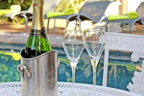 two champagne glasses in an ice bucket on a table at Somerset Wineland Apartments & Wellness in Somerset West
