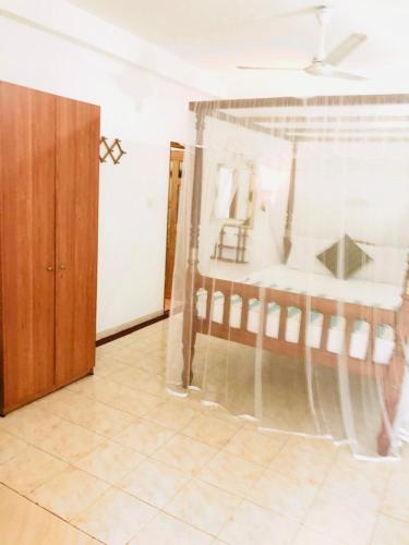 a bedroom with a bed in a room at Castle Bay Resort in Weligama