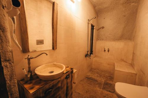 a small bathroom with a sink and a shower at Lubberona Cave Cappadocia in Nar