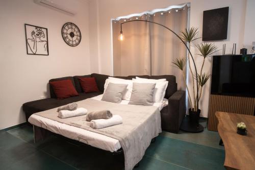 a living room with a bed and a couch at 2 bedroom with 200m to sea - beach and relax in Paphos City