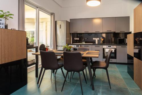 a kitchen with a wooden table and chairs at 2 bedroom with 200m to sea - beach and relax in Paphos City