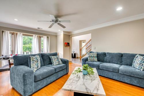 a living room with two blue couches and a table at 5 Mi to Lake Acworth Georgia Gem with Private Patio in Acworth