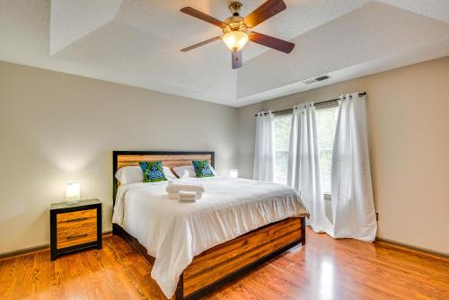 a bedroom with a bed with a ceiling fan and a window at 5 Mi to Lake Acworth Georgia Gem with Private Patio in Acworth