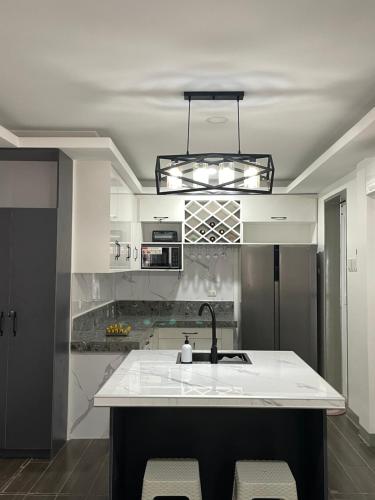 a kitchen with a sink and a counter top at Casa Anaya Vacation Beachfront Home in Toledo City