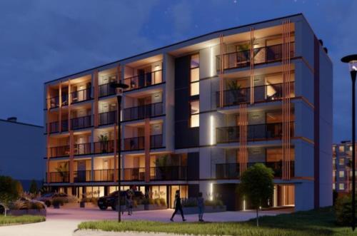 Ein Gebäude mit Leuten, die davor laufen. in der Unterkunft Przystań Klonowa in Kielce