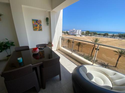 a living room with a large window with a view of the beach at Panorama Apartment Zone Touristique Haut Standing in Mahdia