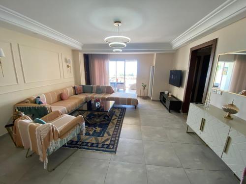 a living room with a couch and a table at Panorama Apartment Zone Touristique Haut Standing in Mahdia