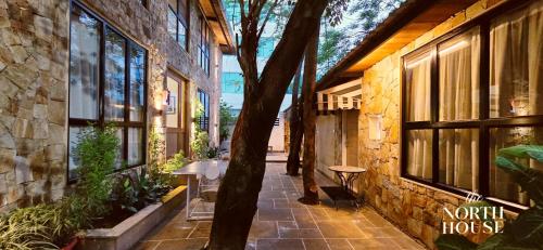 a building with a tree in the middle of a sidewalk at Hotel North House - Best Boutique Hotel in Haldwani in Haldwāni