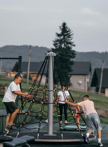 a group of men playing on a play equipment at Stara Pravda Hotel in Bukovel