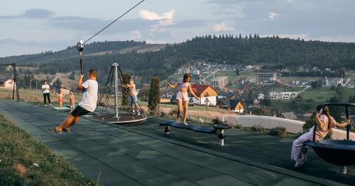a group of people playing on a playground at Stara Pravda Hotel - Vykrutasy in Bukovel