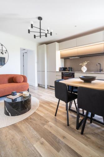 a living room with a table and a couch at Newly Designed, 2br Apt, 5min from Northwood London Tube Station, NATO HQ, Ideal for Wembley, Warner Studio, Contractors in Northwood