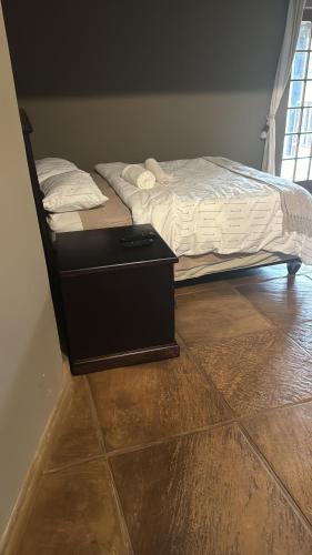 a bedroom with a bed and a dresser next to it at Joes Country lodge in White River
