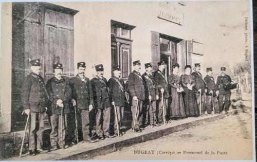 an old photo of a group of men standing outside a building at L'AnciennePoste in Bugeat