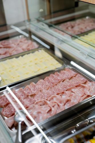 a display of meats and cheeses in a store at Hotel Regina in Caorle