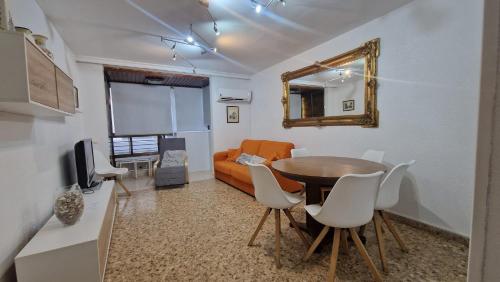 a living room with a table and a couch at La Explanada in Alicante