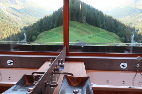 a bathroom with two sinks and a large window at Rumwaldhof - Wohnung Calendula in Solda