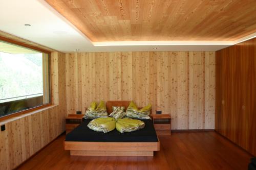 a bedroom with a bed with yellow pillows at Rumwaldhof - Wohnung Calendula in Solda