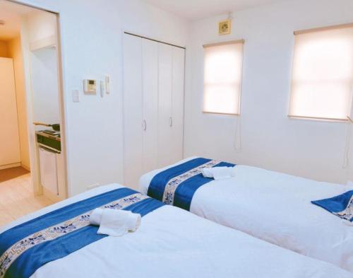 two beds sitting next to each other in a room at F HOUSE Os Residence S3 in Osaka