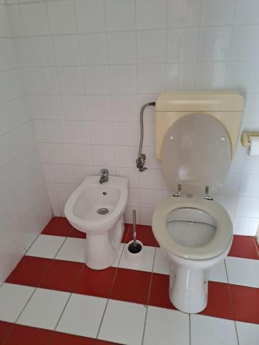 a bathroom with a toilet and a bidet at Budget Cozy in Pula
