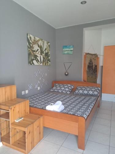 a bedroom with a large bed with a wooden frame at Budget Cozy in Pula