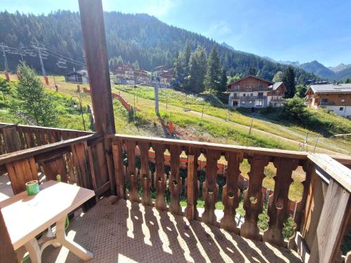 a balcony with a table and a view of a mountain at Studio de 17m² pour 3 pers, balcon, Valfréjus - FR-1-265-231 in Valfréjus