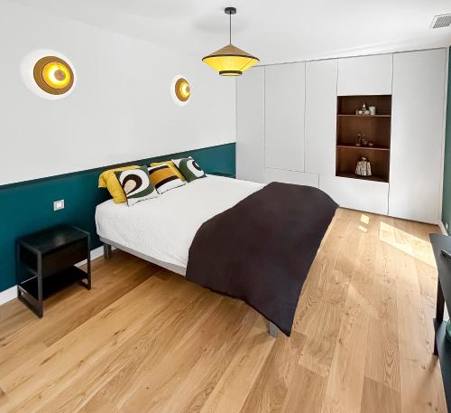 a bedroom with a large bed and a wooden floor at Villa d'Exception avec piscine & spa à Mérignac - Aeroport - Tram direct centre - Aéroparc Business Center Mérignac - Airbus Thales Safran - Hôpital Charles Perrens - Hôpital Pellegrin - ZI Espace Mérignac Phare in Mérignac