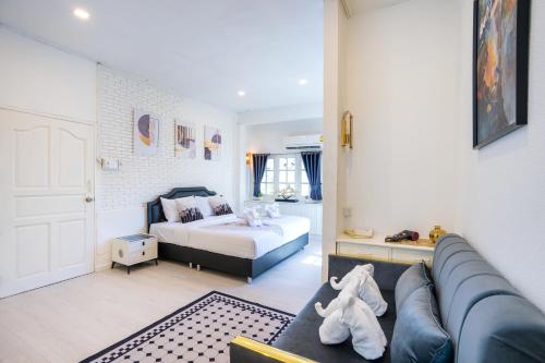 a living room with a bed and a couch at Your Sea Cret pool villa in Jomtien Beach
