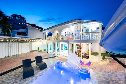 an exterior view of a house with a butterfly sculpture at Your Sea Cret pool villa in Jomtien Beach