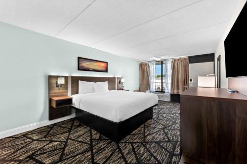 a hotel room with a bed and a television at Clarion Inn & Suites near the Leconte Center Pigeon Forge in Pigeon Forge