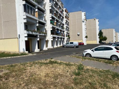 a white car parked in front of a building at Mini Premium in Miskolc