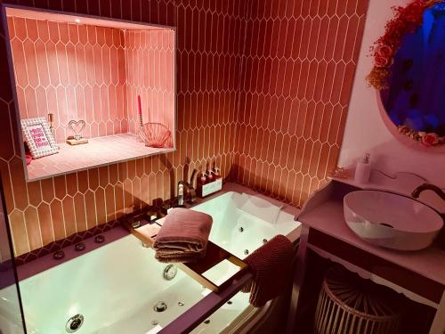 a bathroom with a bath tub and a sink at LOVE Room - Balnéo - Ciel Etoilé - Free Wifi - Netflix - Hyper Centre in Pézenas