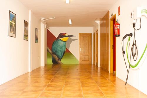 a painting of a bird on the wall in a hallway at Casa Nuri de Rei La Pobla Tornesa in Puebla Tornesa
