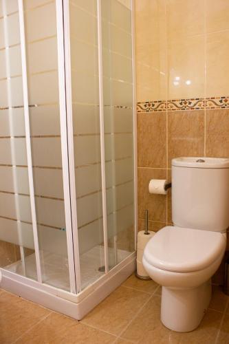 a bathroom with a toilet and a glass shower at Casa Nuri de Rei La Pobla Tornesa in Puebla Tornesa