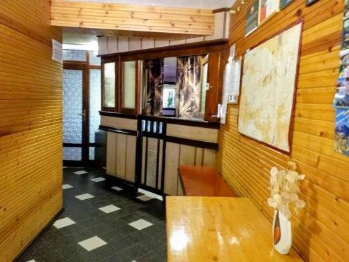 a room with a table and a wooden wall at Zodiac House in Samokov