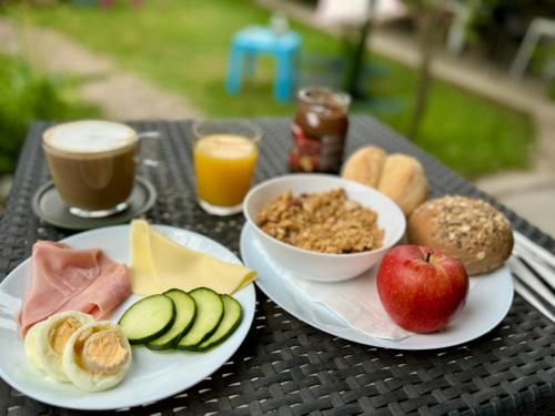 a table with two plates of breakfast food on it at Urban Garden Porto Central Hostel in Porto