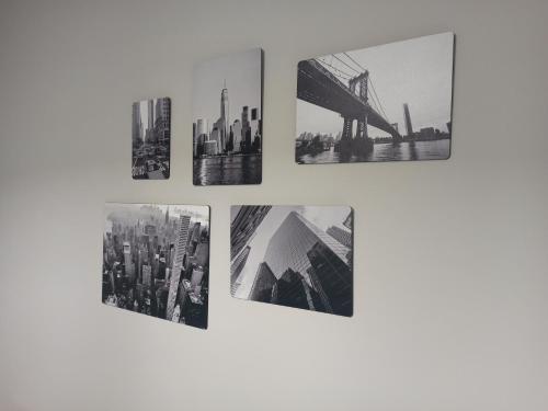 a group of four pictures hanging on a wall at Le Mirage in Chieti