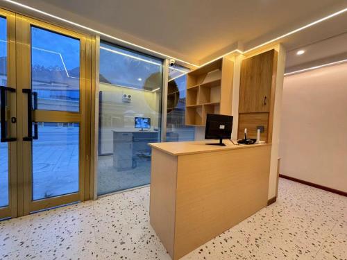an office with a desk with a computer on it at 红柳花雪山观景民宿 in Taxkorgan