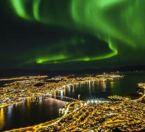 an aerial view of a city with the aurora at Apartment in Tromsø - Close to everything - Free parking in Tromsø