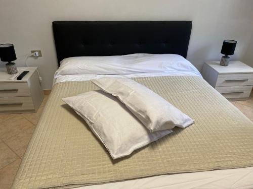 a bed with white pillows on top of it at Suite Morruzze in Morruzze