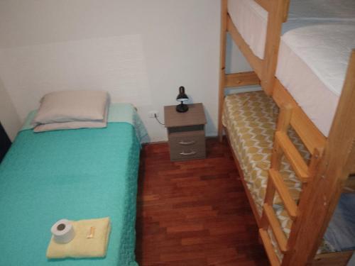 a small bedroom with a bunk bed and a ladder at Arena Costa Lima rooms Peru in Lima