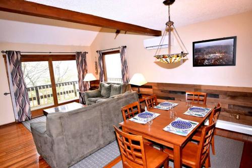 a living room with a table and a couch at Ski-In Ski-Out Camelback Village Townhouse - 100 YDS From The Mountain in Crescent Lake