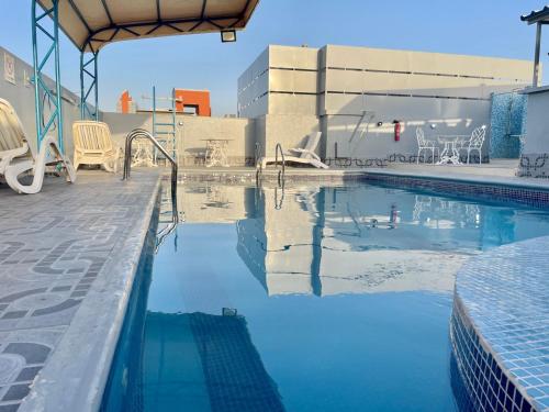 a swimming pool with blue water in a building at Le Paradise Palace Hotel Deira Dubai Al Rigga in Dubai