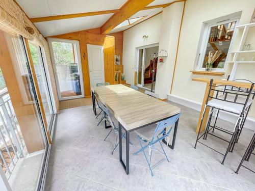 a dining room with a wooden table and chairs at Villa de Charme en Haute-Savoie in Clarafond