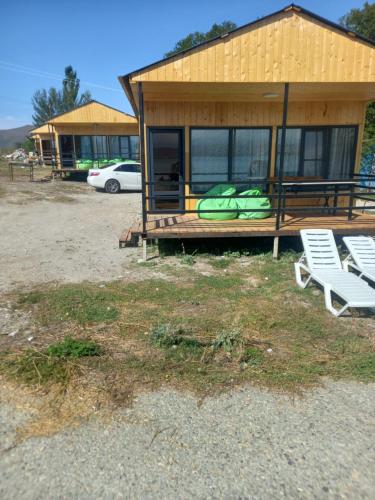 a house with two white chairs and a building at Нирок 2 in Sevan