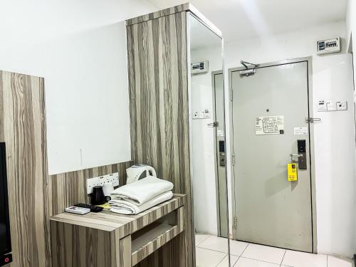 a bathroom with a shower and a sink and a mirror at Ho Hotel in Melaka